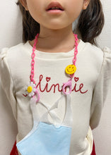Load image into Gallery viewer, Pink Plastic Mask Holder with Daisy and Smiley Face Charms