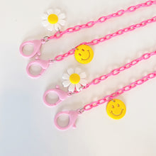 Load image into Gallery viewer, Pink Plastic Mask Holder with Daisy and Smiley Face Charms